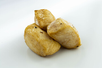 fresh baked chicken cubes on white background