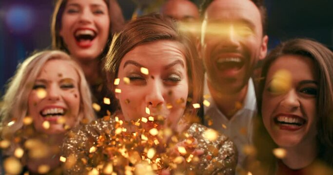 Confetti celebration, glitter and friends at a party, happy social and night portrait at a club. Disco sparkle, group celebrate and people with happiness on new years in a dark night club together