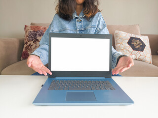 mockup laptop. asian woman showing new model laptop to recommend buying advice in casual jean jacket on white table