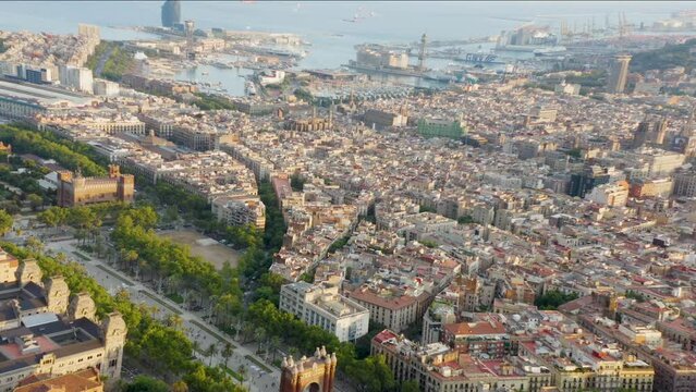 high backward drone flight with a view of the port and city center of barcelona in spain
