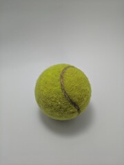 Dirty tennis ball isolated on white background.