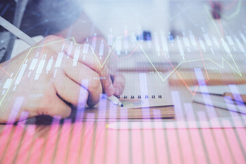 Multi exposure closeup hands with stock market forex graph.