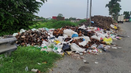 A pile of rubbish on the roadside because of littering make the environment dirty