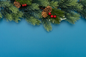 Fototapeta na wymiar Christmas composition. festive decor on blue background. Copy space, flat lay, top view.