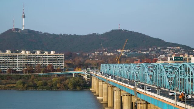 Road Traffic At Dongjak Bridge Over The Han River With Namsan Tower In The Background In Seoul, South Korea. - wide