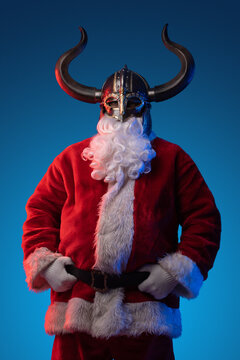 Portrait of santa claus dressed in red coat and helmet of vikings.