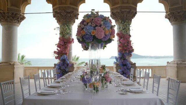 Wedding table decorated with flowers with the sea view, Italy