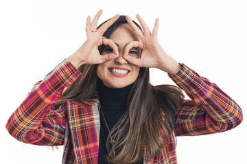 Young smiling brunette woman holding fingers around her eyes, isolated on white background. High...