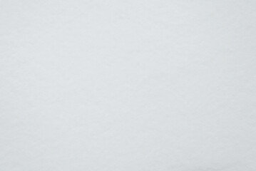 Snow texture background on winter cloudy day, top view