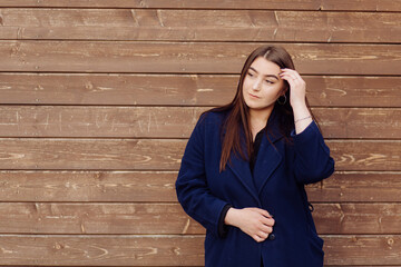 Beautiful Young Stylish Girl in wood background