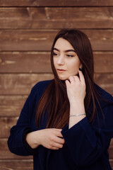 Beautiful Young Stylish Girl in wood background