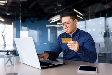 Frustrated asian man trying to make banking transaction and purchase in online store, businessman...