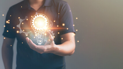 Man holding light bulbs in grey background, iInnovation technology and new idea creativity concept. Creative education concept.