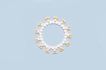 Virus concept made of pills on blue background. Coronavirus  minimal treatment concept.