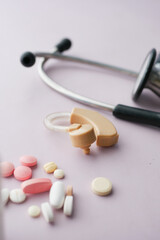 Hearing aid equipment , medical pills on table
