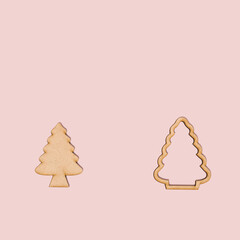 Natural Christmas tree ornament on pastel pink background with copy space. Natural winter frame idea. Minimal concept for New Year or Christmas holiday season.