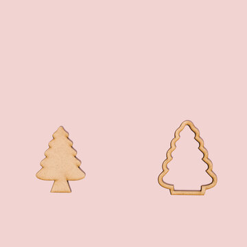 Natural Christmas tree ornament on pastel pink background with copy space. Natural winter frame idea. Minimal concept for New Year or Christmas holiday season.