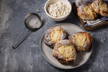 Patties with cottage cheese on a marble table. Russian pastry (vatrushka)