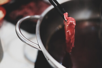 chopsticks with fresh beef and ingredients background for Japanese shabu-shabu or Sukiyaki,...
