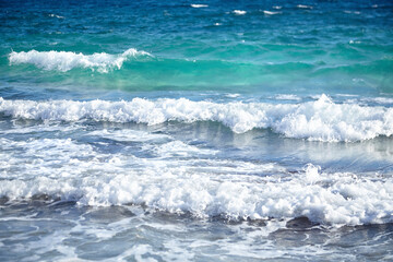 Fototapeta premium Summer sea water with white waves. Empty sand beach with azure water. Summer holiday background