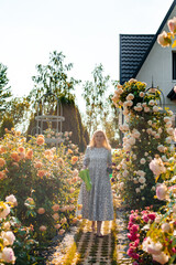 A woman with short blonde hair is working in her beautiful aesthetic garden on a terribly hot...