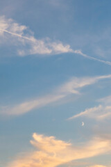 Blue sky with crescent moon and clouds. Nature background.