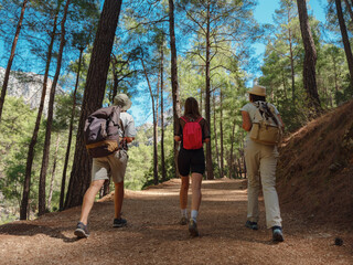 group of Tourists with backpacks hike , Turkey travel, mediterranean area on a warm summer day St Peter's trail. concept of Zero waste travel, active lifestyle, summer vacation concept.