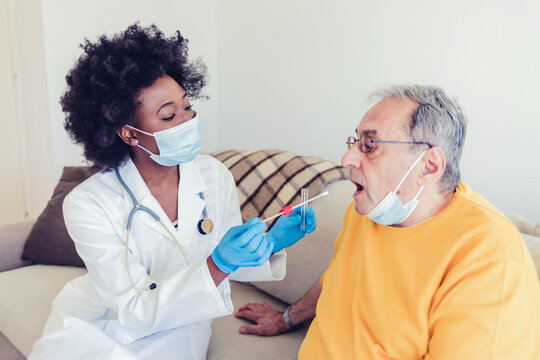 Close-up Of Senior Man Having PCR Test By Female Doctor At Nursing Home.