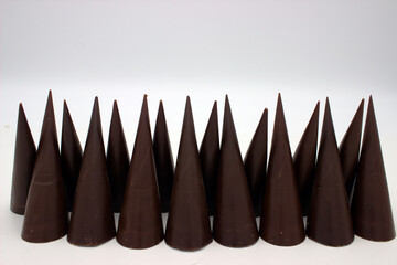 Elongated chocolates on white background