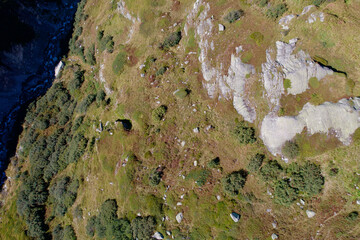 Obraz premium Aerial view of Muttbach creek at Swiss mountain pass Furkapass with Obergoms Valley on a sunny late summer day. Photo taken September 12th, 2022, Furka Pass, Switzerland.