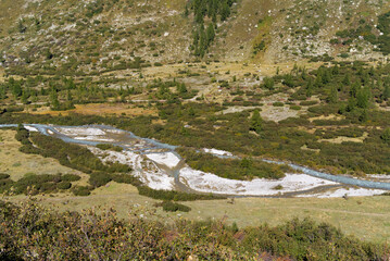 Aerial view of glacier landscape with Rhone River at Swiss mountain hamlet of Gletsch, Canton Valais, on a sunny late summer noon. Photo taken September 12th, 2022, Gletsch, Switzerland.