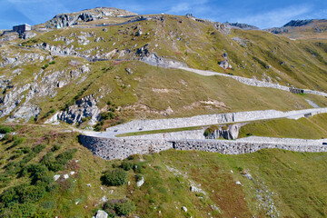 Fototapeta na wymiar Aerial view of mountain panorama in the Swiss Alps at region of Swiss mountain pass Furkapass with serpentine road on a sunny summer day. Photo taken September 12th, 2022, Furka Pass, Switzerland.