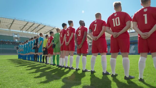 Football Championship: Back View Two Professional Soccer Team ready for a Match. Players One by One, Standing in Line on Stadium. Professional Athletes Ready to Win Tournament, Cup. Dolly Wide Camera