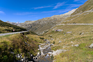 Fototapeta premium Scenic view of famous Swiss mountain pass Furkapass with rocks and mountain peak on a sunny late summer day. Photo taken September 12th, 2022, Furka Pass, Switzerland.