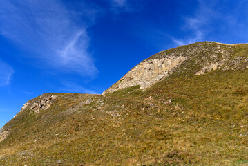 Scenic view of mountain panorama in the Swiss Alps at famous Swiss mountain pass Furkapass on a sunny late summer day. Photo taken September 12th, 2022, Furka Pass, Switzerland.