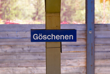 Blue and white sign at platform of railway station of Swiss mountain village Göschenen, Canton Uri, on a sunny late summer afternoon. Photo taken September 12th, 2022, Göschenen, Switzerland.