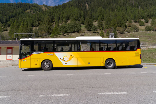 Yellow Swiss Post bus line 161 at bus station of mountain village Oberwald, Canton Valais, on a late summer sunny noon. Photo taken September 12th, 2022, Oberwald, Switzerland.