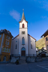 Fototapeta premium Mountain village Realp, Canton Uri, with catholic church on a late summer day. Photo taken September 12th, 2022, Realp, Switzerland.