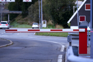 Closed barrier at car shuttle train terminal at mountain village Realp at Swiss mountain pass Furkapass on a sunny late summer morning. Photo taken September 12th, 2022, Realp, Switzerland.