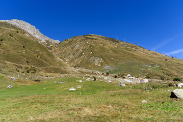 Fototapeta na wymiar Scenic landscape at Swiss mountain valley Urserntal, Canton Uri, in the Swiss Alps on a sunny late summer day. Photo taken September 12th, 2022, Ursern Valley, Switzerland.
