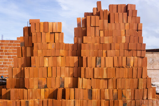 Stack of orange clay bricks for homebuilding in Brazil
