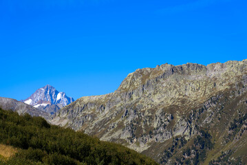 Impressive panoramic landscape in the Swiss Alps with peak Finsteraarhorn at region of Swiss mountain pass Furkapass on a sunny day. Photo taken September 12th, 2022, Furka Pass, Switzerland.