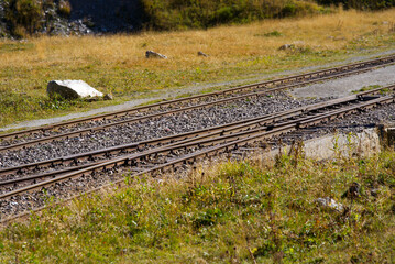 Narrow gauge railway switch at Swiss mountain pass Furkapass, Canton Valais, on a sunny late summer...