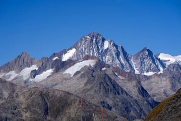 Impressive panoramic landscape in the Swiss Alps with peak Finsteraarhorn at region of Swiss mountain pass Furkapass on a sunny day. Photo taken September 12th, 2022, Furka Pass, Switzerland.