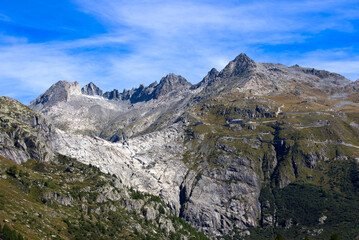 View of famous Rhone Glacier with Rhone River in the Swiss Alps with glacier river on a sunny late summer day. Photo taken September 12th, 2022, Furka Pass, Switzerland.