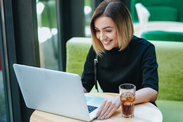 businesswoman with smart phone and notebook in coffee shop