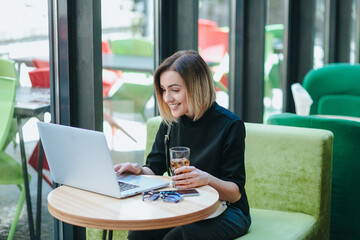 businesswoman with smart phone and notebook in coffee shop