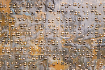 rusty iron sheet with dense screws