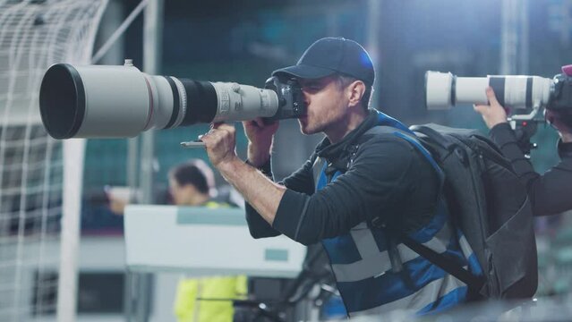 Professional Press Officer, Sports Photographers with Camera with Zoom Lens Shooting Football Championship Match on a Stadium. International Cup, World Tournament Event. Photography, Journalism, Media