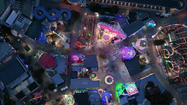 Aerial view fun fair. Twilight time illumination Vienna city famous theme amusement park Prater riverside downtown aerial panorama 4k Austria